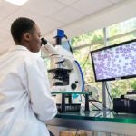 A scientist using a digital microscope