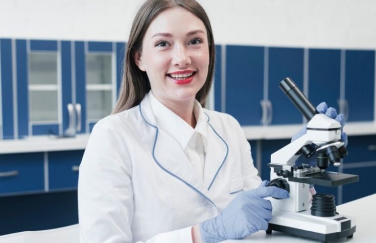 happy scientist using microscope